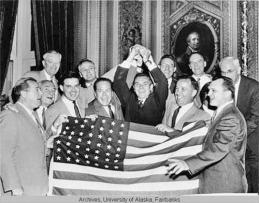 Alaska Territorial Gov. Bob Bartlett in center, with the 49-star flag (Bartlett was one of Alaska's first U.S. senators).