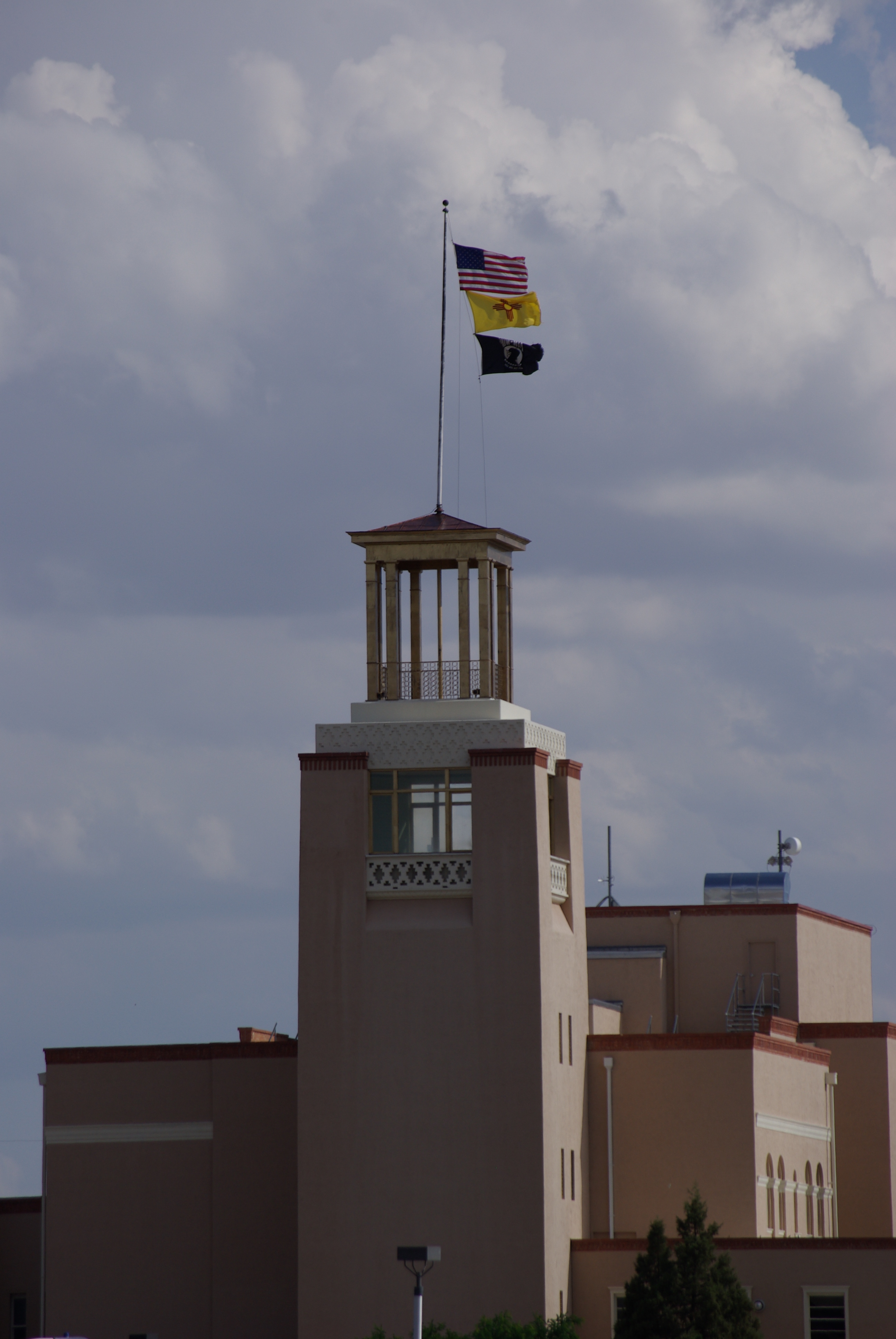 U.S. and New Mexico flags fly from the state education administration building in Santa Fe, 2014