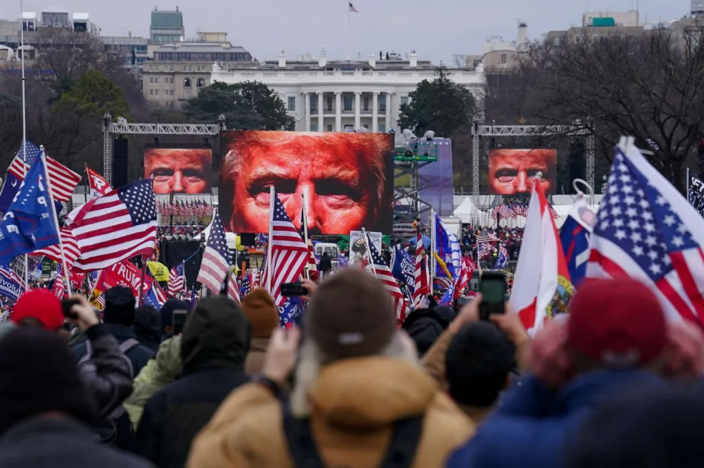 Trump images loom over crowd at Ellipse rally, as Trump incites them to attach the Capitol building and Congress, January 6, 2021. John Minchillo, AP